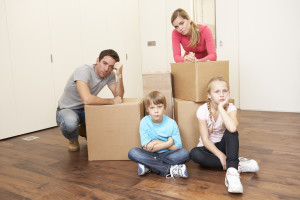 Young family looking upset among boxes